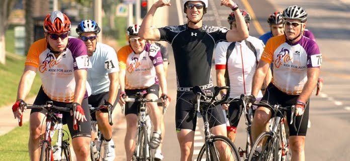 Group of LGBTQ+ cyclists riding in the Annual Orange County Ride for AIDS event